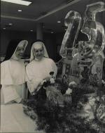 Adrian Dominican Sisters arranging a 25th Barry College anniversary ice sculpture